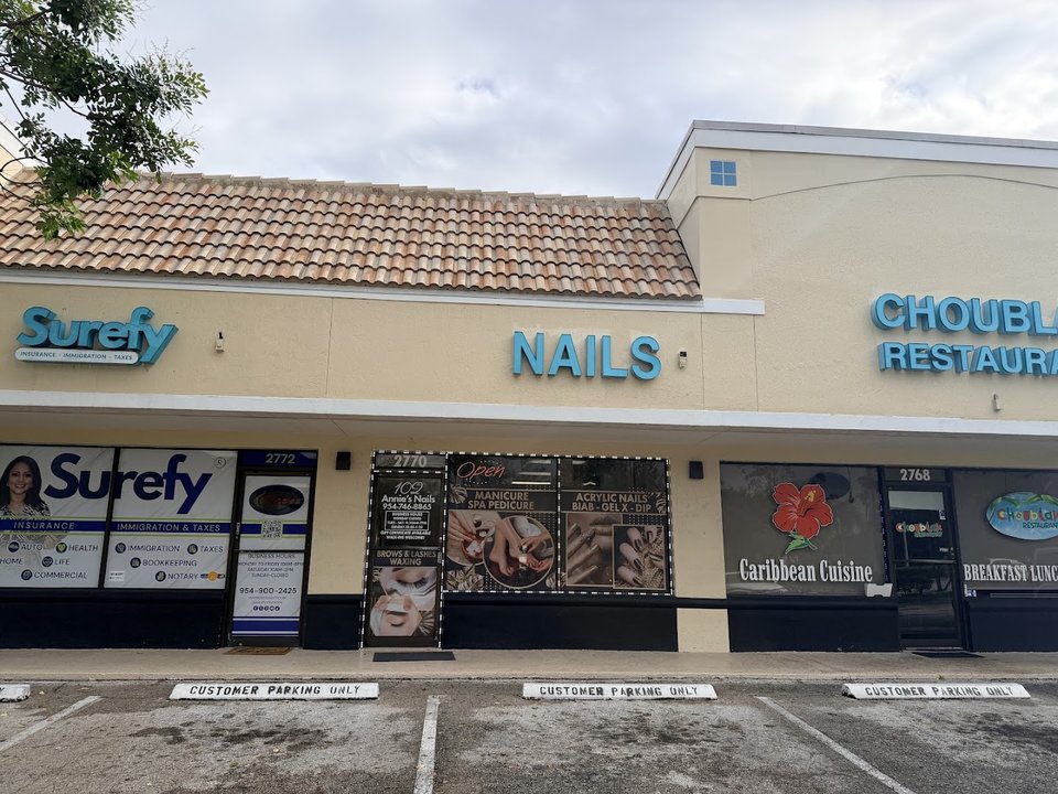 Nail technician working on acrylic nails